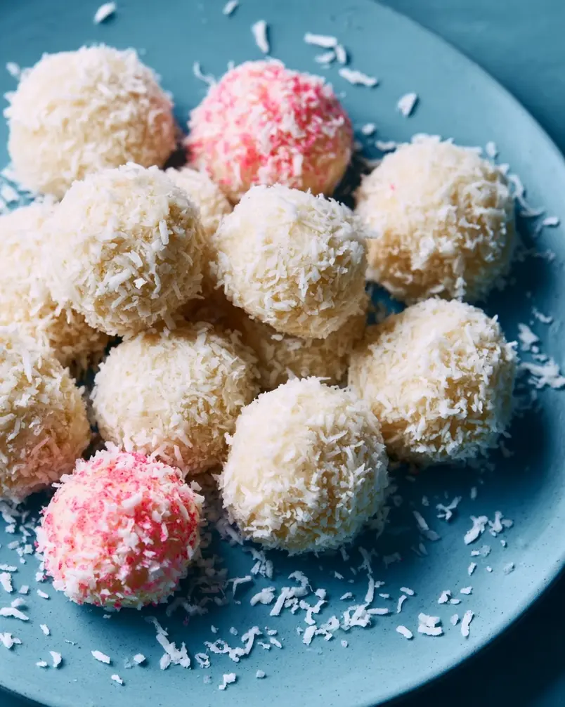 Coconut Cake Snowballs 3 Baking sheet filled with golden brown Coconut Cake Snowballs fresh out of the oven