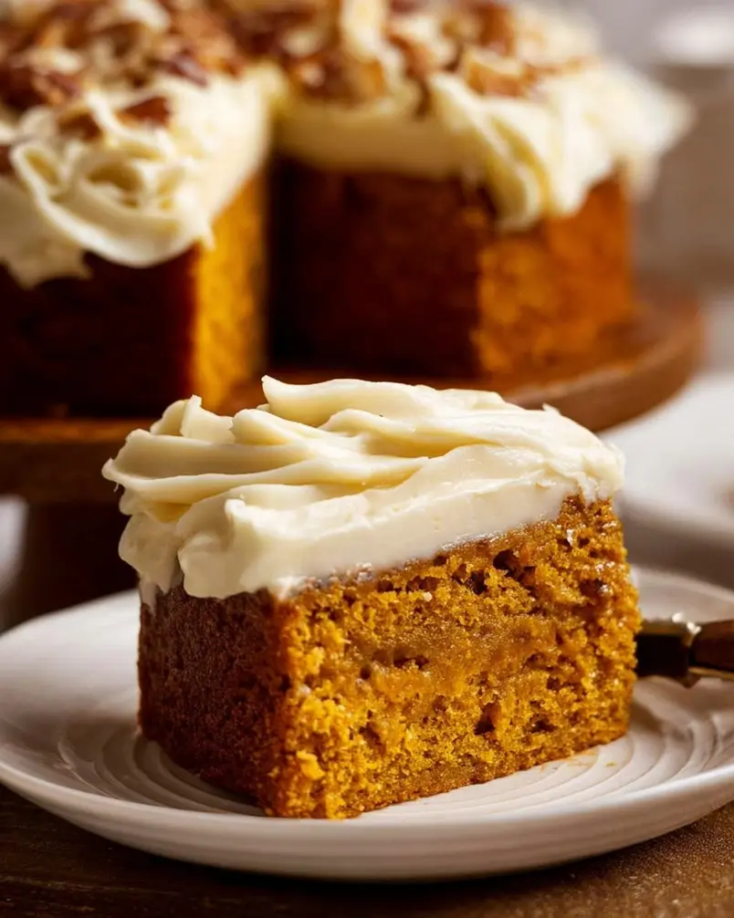 Pumpkin Cake with Cream Cheese Frosting 3 Batter for pumpkin cake with cream cheese frosting being poured into a baking pan.